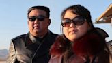 Kim Jong-un and daughter sport leather trenchcoats and sunglasses as they inspect 'dazzling' new aircraft