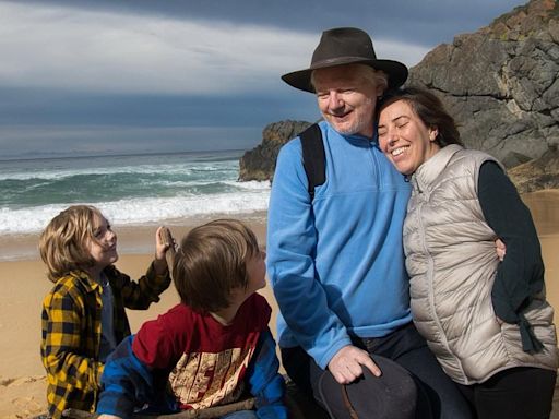 Julian Assange poses with his wife and children on Australian beach