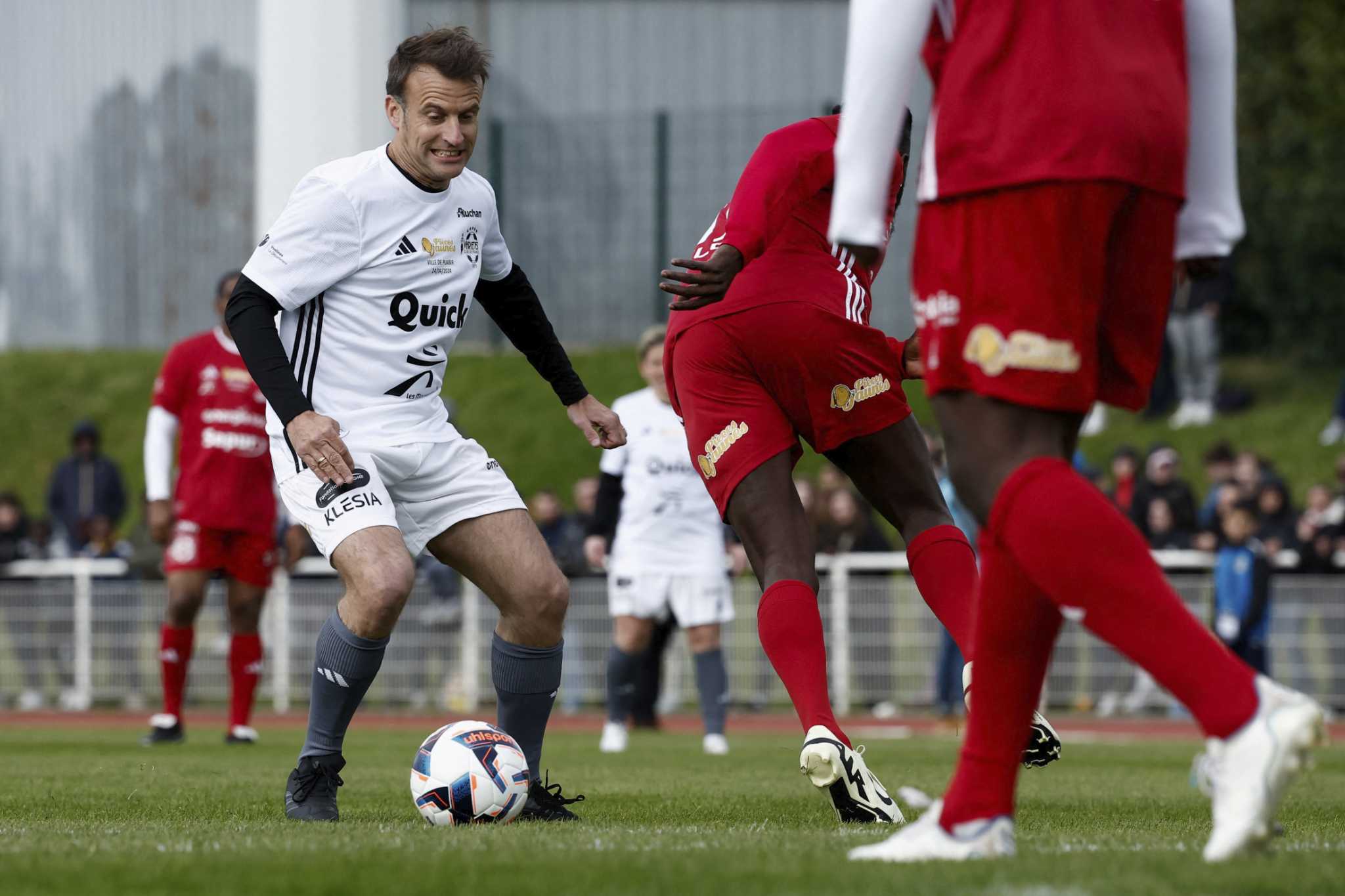 Macron takes part in charity soccer game, showing off sporting prowess