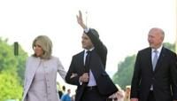 President Emmanuel Macron, centre, and his wife Brigitte Macron with Berlin's Mayor Kai Wegner at the Brandenburg Gate in Berlin on Sunday