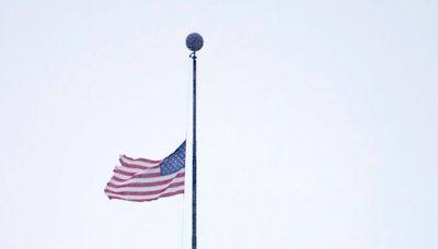 Why are flags flying at half-staff in Wisconsin today?