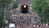 Tens of thousands gather in Belgrade protest over mass shootings