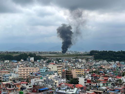 A plane slips off the runway and crashes in Nepal, killing 18 passengers and injuring the pilot