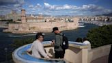 The Olympic torch is being welcomed in French port city of Marseille with fanfare and high security