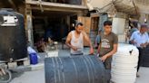 Gaza workshop repairs water tanks hit by bullets, bombs