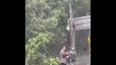 China: Selfless Man Lifts Downed Wire Wth Spade For Passing Cars In Rain