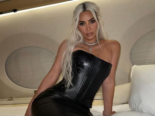 Kim Kardashian Strikes a Pose in Leather Set on Bed in Her Private Jet — Yes, There's a Corset