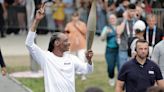 Snoop Dogg carries the Olympic torch before opening ceremony in Paris