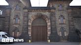 Woman charged over alleged inmate and officer sex video