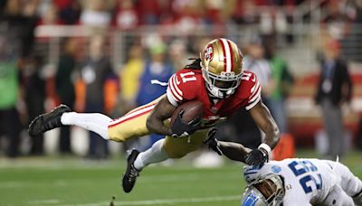 49ers' Aiyuk reports to camp despite requesting trade