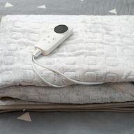 These are smaller than regular electric blankets and are designed to be used while sitting. They are often used on couches or chairs while watching TV or reading. They come in various sizes and designs.