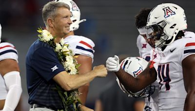 Why does Arizona football coach Brent Brennan wear a lei at games?