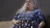 Elaine Simons, the foster mother of Jesse Sarey, holds a photo of her foster son on a bench in the backyard of her Renton home Wednesday, April 10, 2024. She plans to spend a lot more time on benches similar to this one as she sits in court during the trial for the...