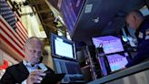 Wall St closes higher as investors return to megacap stocks