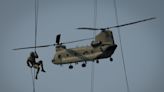 Iowa National Guard members rappel from helicopters during Air Assault School training