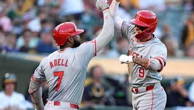 The Los Angeles Angels' Zach Neto and Jo Adell celebrate after Neto hit a solo home run against the Oakland Athletics in the fourth inning...