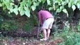 man trying to chip shot out of the woods almost hits his friend