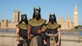 Moment drivers stop as trio dressed as Egyptian Gods stroll along busy street