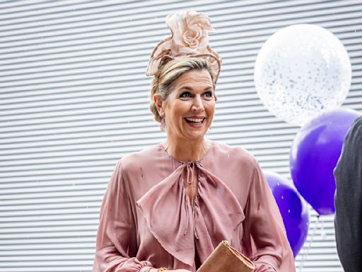 Queen Maxima of the Netherlands Opts for Whimsical Dressing in Playful Dusty Rose Dress and Floral Hat at Amsterdam College