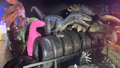 Truck hauling life-sized dinosaurs crashes on highway after storm