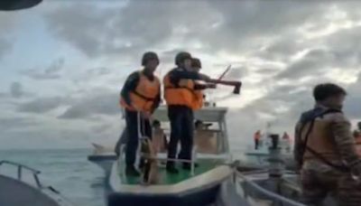 Video shows Chinese coast guard brandishing an ax in a low-tech clash with the Philippines navy