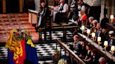 Photos show the Queen's coffin being lowered into the Royal Vault at St George's Chapel