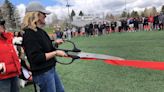 A quick huddle of hundreds cuts the ribbon on new Dozier Field scoreboard