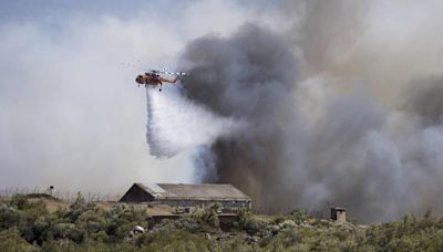 Two wildfires are burning near Greece’s capital, fueled by strong winds