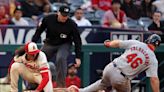 ...Paul Goldschmidt steals third base ahead of the throw to Los Angeles Angels' Cole Tucker, left, during the third inning at Angel Stadium of Anaheim on Tuesday, ...