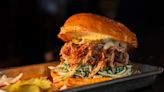 Barbecue stand in Dallas sells brisket sliders in a parking lot behind El Fenix