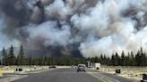 Wind-driven wildfire spreads outside a central Oregon community and prompts evacuations