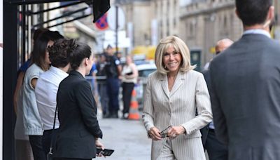 Brigitte Macron chic en rose poudré : épaulettes et détails, elle dévoile ses jambes dans un tailleur élégant