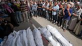 An airstrike kills 20 in central Gaza and fighting rages as Israel’s leaders air wartime divisions