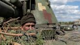 Ukraine troops say they take key town, Putin ally mulls possible nuclear response