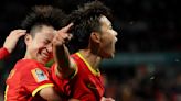 China edges Haiti 1-0 to keep World Cup hopes alive despite going down to 10 players