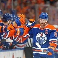 Edmonton's Connor McDavid celebrates a power play goal with teammates on the bench as the Oilers beat Dallas and advanced to the NHL Stanley Cup Final against Florida