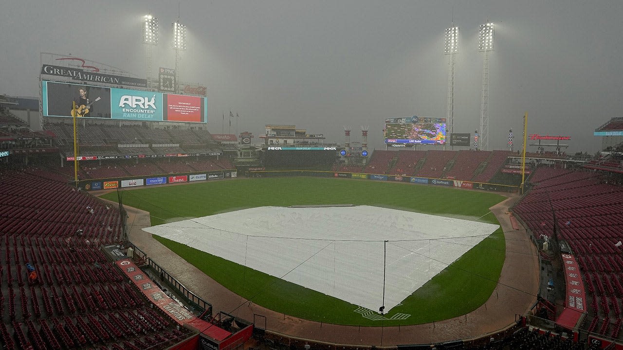 MLB grounds crew member gets trapped under tarp in rain delay