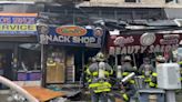 3 firefighters injured after store signs come crashing down at scene of Washington Heights fire