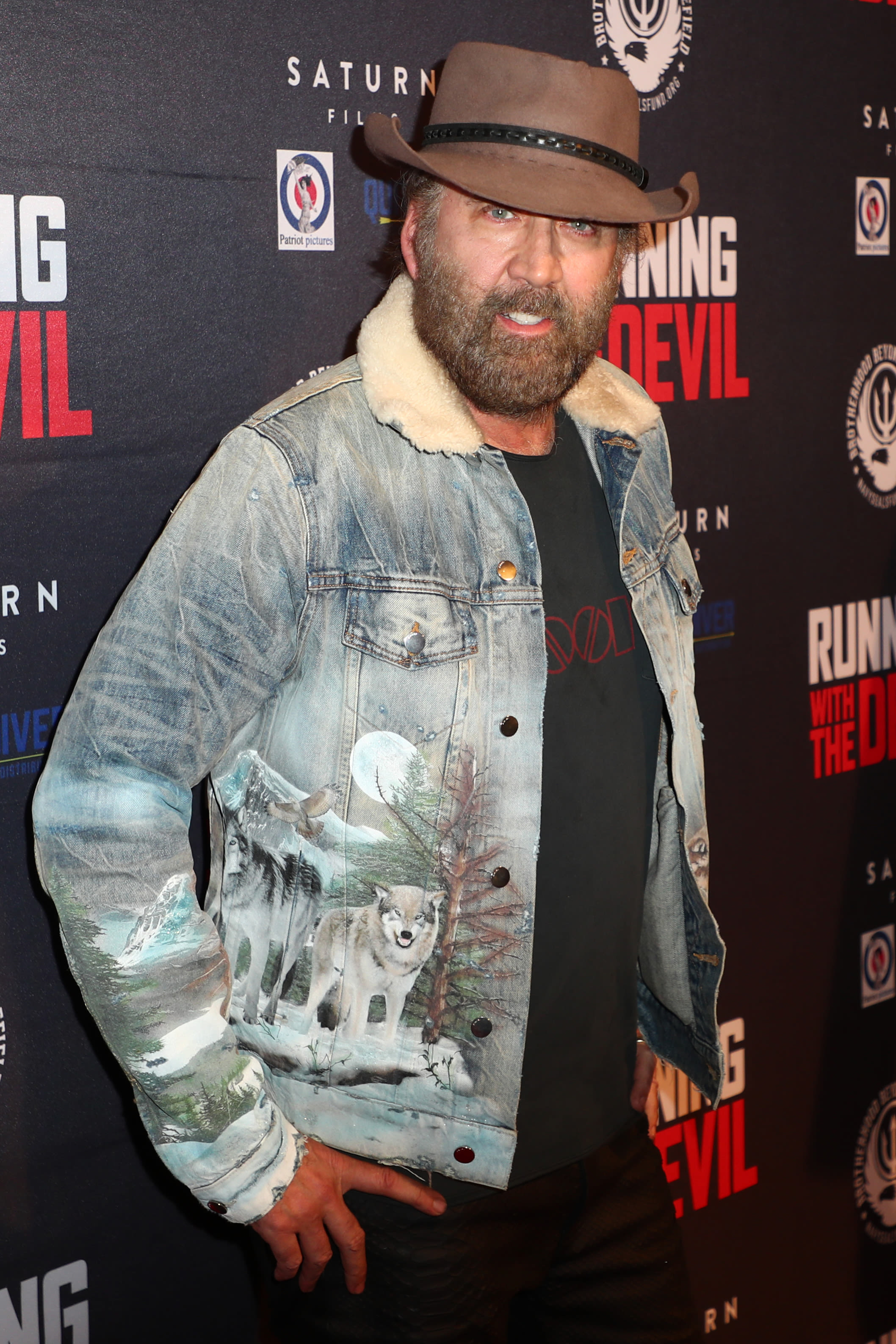 Nicolas Cage's bushy beard and cowboy hat are out in full force at movie premiere