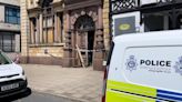 Police forensics teams at work inside disused bank