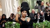 See Cardi B’s Met Gala Arrival as Nine Men Helped Carry Rapper’s Massive Black Gown