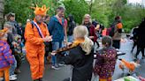 Orange crush: Boats packed with revelers tour Amsterdam canals celebrating the King's birthday