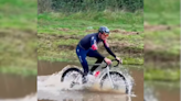 Powerful Cyclist Blasts Through Puddle While Fellow Riders Walk