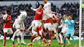 Arsenal hang on to beat Spurs, maintain lead at top