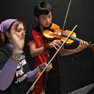 Sharing a few notes: High schoolers coaching younger string players one on one