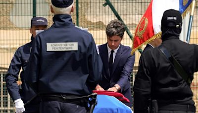 France pays tribute to prison officers, attackers still at large
