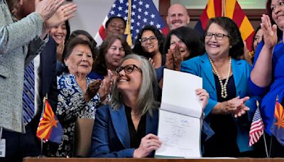 Arizona's Democratic governor signs a bill to repeal 1864 ban on most abortions