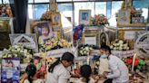 Grieving families mourn through night in temples after 23 children massacred at Thailand nursery