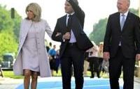 President Emmanuel Macron, centre, and his wife Brigitte Macron with Berlin's Mayor Kai Wegner at the Brandenburg Gate in Berlin on Sunday