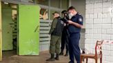 A gunman wearing a swastika t-shirt killed at least 13 people and wounded 21 in a Russian school, officials said